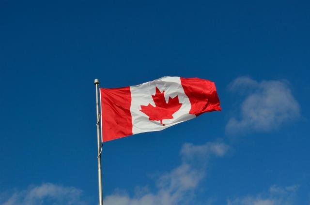 Canada flag against blue sky
